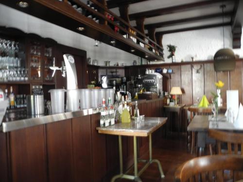 a restaurant with a bar with tables and chairs at Paciello Restaurant Hotel in Velbert