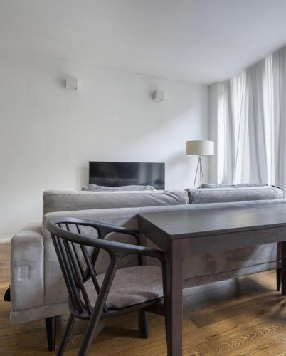 a bedroom with a bed and a table and a chair at Amazing 3 Bedrooms in Mayfair in London