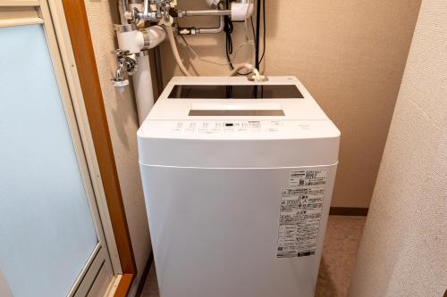 a white washer and dryer in a room at stay in tokiwa in Asahikawa