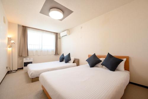 a hotel room with two beds and a window at stay in tokiwa in Asahikawa