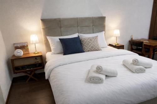 a bedroom with a large bed with towels on it at Garden Lux Grujić Apartmani in Krivi Vir