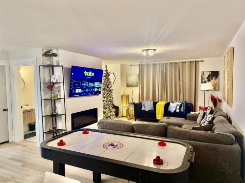 a living room with a couch and a table at Platinum Homes , Stylish 3BR Home,4 Min to YQM Airport, Sleeps 10 Free Parking in Dieppe