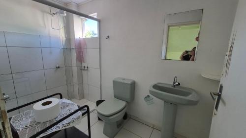 a bathroom with a toilet and a sink and a mirror at Terraço do Sol Apt 03 in Marcelino Ramos