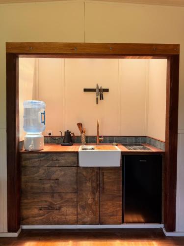 a kitchen with a sink and a blender on a counter at The Village Eco Stay Byron Bay in Byron Bay