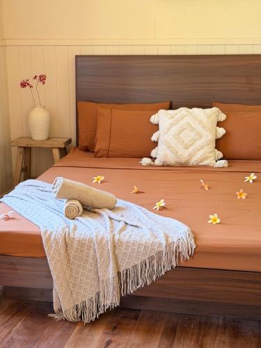 a bedroom with a bed with flowers on it at The Village Eco Stay Byron Bay in Byron Bay
