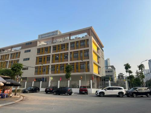 a large building with cars parked in a parking lot at Hoa baby 302TK21 in Hanoi