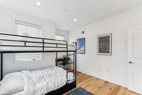 a bedroom with a bunk bed and white walls at Modern 3BR Walk to Museums in Philadelphia