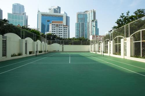 a tennis court with a city in the background at Somerset Grand Citra Jakarta in Jakarta