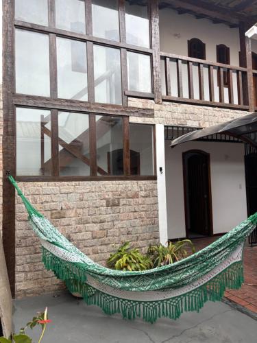 a hammock in front of a building at L Grace Centro in Búzios