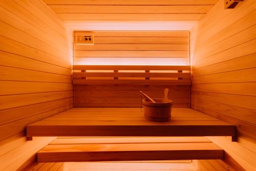 a wooden sauna with a bucket in the middle at One Harajuku: Private Oasis in Tokyo