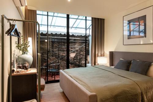 a bedroom with a bed and a large window at Nap Old Town in Bangkok