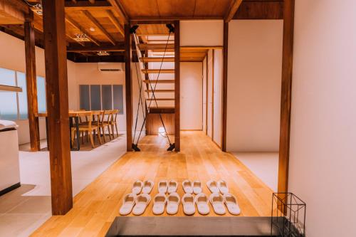a row of shoes on the floor in a room with a table at One Harajuku: Private Oasis in Tokyo