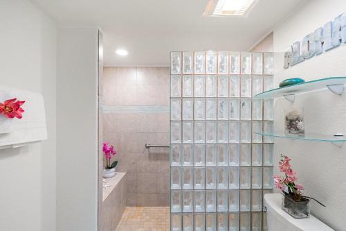 a bathroom with a shower with glass block walls at Lahaina Shores 212 in Lahaina