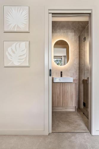 a bathroom with a sink and a mirror at Bonnyvale Dune Retreat I Ocean Grove in Ocean Grove
