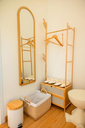 a bathroom with a bath tub and two mirrors at Yugen House - Yuma in Nong Prue