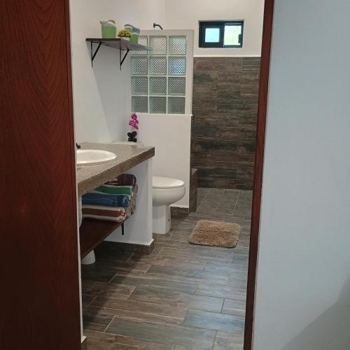 a bathroom with a toilet and a sink at Casa Loto D in Chelem