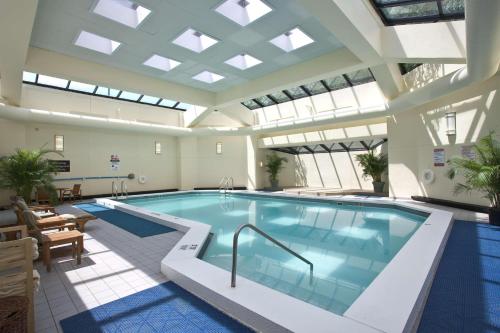 a pool in a building with a large ceiling at DoubleTree by Hilton Stamford in Stamford