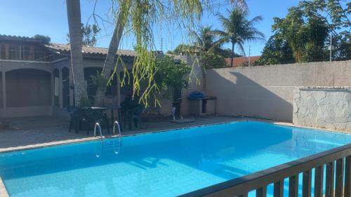a swimming pool in a backyard with a fence at Med House in Guaíra