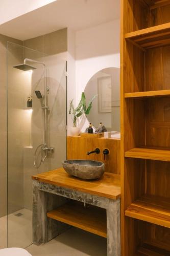 a bathroom with a stone sink and a shower at 2BR Private Pool Beach Villa Near Sanur & Ubud in Ketewel