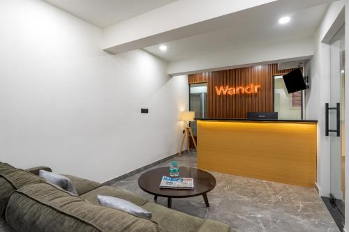 a living room with a couch and a waiting area at Wandr Hotel Richmond Road in Bangalore