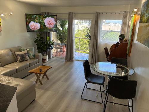a living room with a couch and a glass table at ZenCBD, Hidden Gem in Cairns