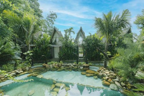 einen Pool vor einem Haus mit Garten in der Unterkunft LIA Retreat & Coffee 