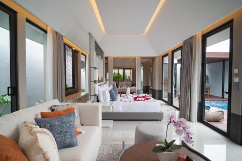 a living room with a couch and a bed at Javana Royal Villas in Seminyak