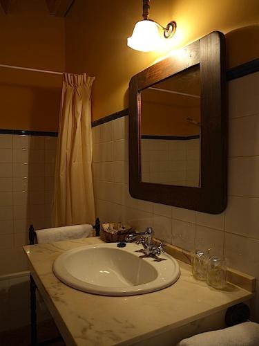 a bathroom with a sink and a mirror at Posada Molino del Canto in Barriolacuesta