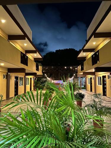 a group of buildings with plants in front of them at Hotel Framfor Inn Chetumal in Chetumal