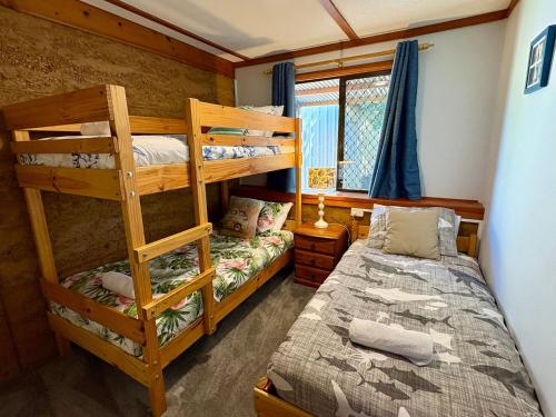 ein Schlafzimmer mit zwei Etagenbetten und einem Bett in der Unterkunft Macbeth Family Stay in Busselton