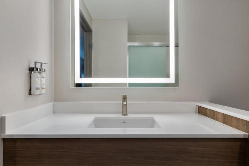 a bathroom with a white sink and a mirror at Holiday Inn Express & Suites Steamboat Springs by IHG in Steamboat Springs