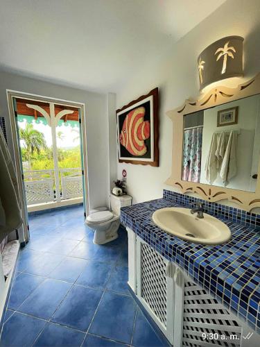 a bathroom with a sink and a toilet at La Dolce Vita 12 Beachfront Hotels, Las Terrenas, Samana in Las Terrenas
