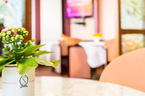 a vase of flowers sitting on top of a table at Hotel Ristorante SASSO in Bovolone
