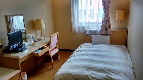Postel nebo postele na pokoji v ubytování Hotel Hitachi Hills