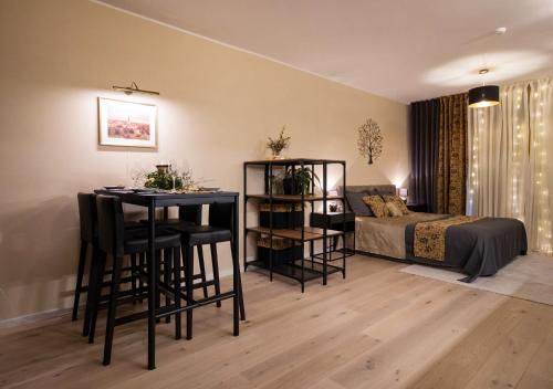 une chambre avec un lit, une table et des chaises dans l'établissement Das Appartement Tallinn, à Tallinn