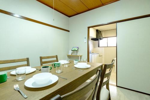 a dining room with a table with white plates on it at F-City 中葛西 I in Tokyo