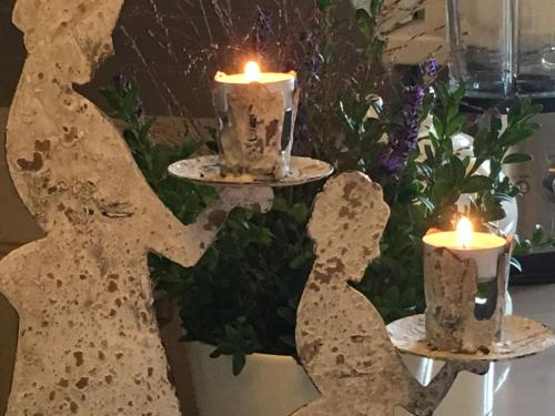 a table with two candles and a candle holder at Landhausvilla Strittberg 7 in Höchenschwand
