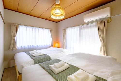 Postel nebo postele na pokoji v ubytování F-City 中葛西 I