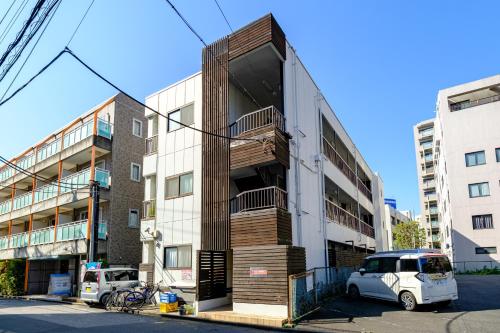 aartment building with a wooden staircase on the side of it at F-City 中葛西 I in Tokyo