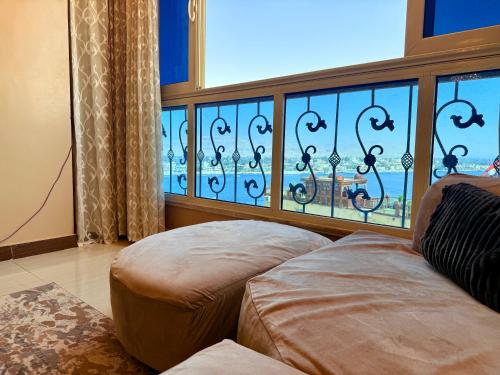 ein Zimmer mit einem Sofa und einem großen Fenster in der Unterkunft Princes Palace in Luxor