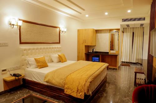 a bedroom with a large bed in a room at NTS Nirvana Suites in Bangalore