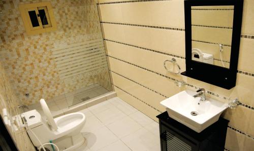 a bathroom with a toilet and a sink and a shower at West Liberty in Jeddah