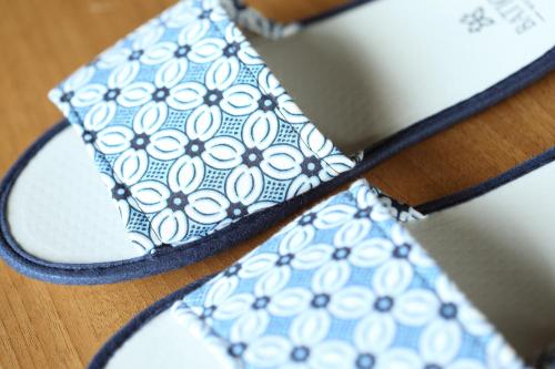 a pair of shoes with a blue and white tie at BATIQA Hotel Lampung in Bandar Lampung