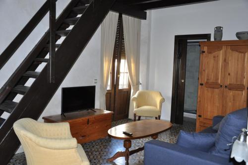 a living room with a blue couch and a tv at Casa de las Remigias in Estepona