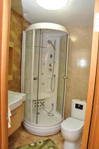 a bathroom with a shower and a toilet at ART Hostel in Almaty
