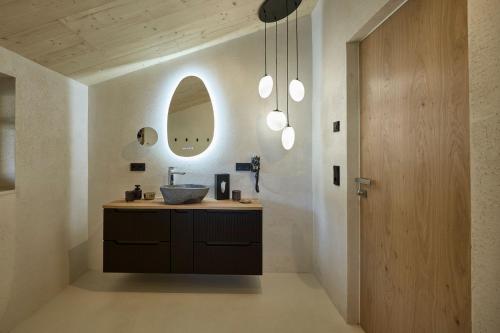 a bathroom with a sink and a mirror at fuchs am meer in Mitterhofen