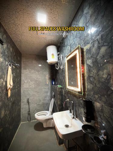 a bathroom with a sink and a toilet at Awadh kunj palace in Ayodhya