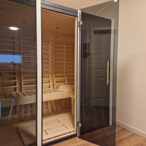 a glass door leading into a walk in closet at Ferienhaus Marie in Wittenbeck