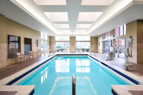 a swimming pool in a hotel with a large ceiling at Hyatt House Seattle Bellevue in Bellevue