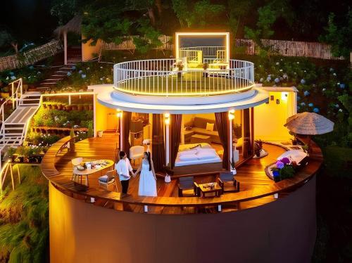 a house with a bride and groom standing on a deck at Rai hemuxnfa Villa in Mae Rim
